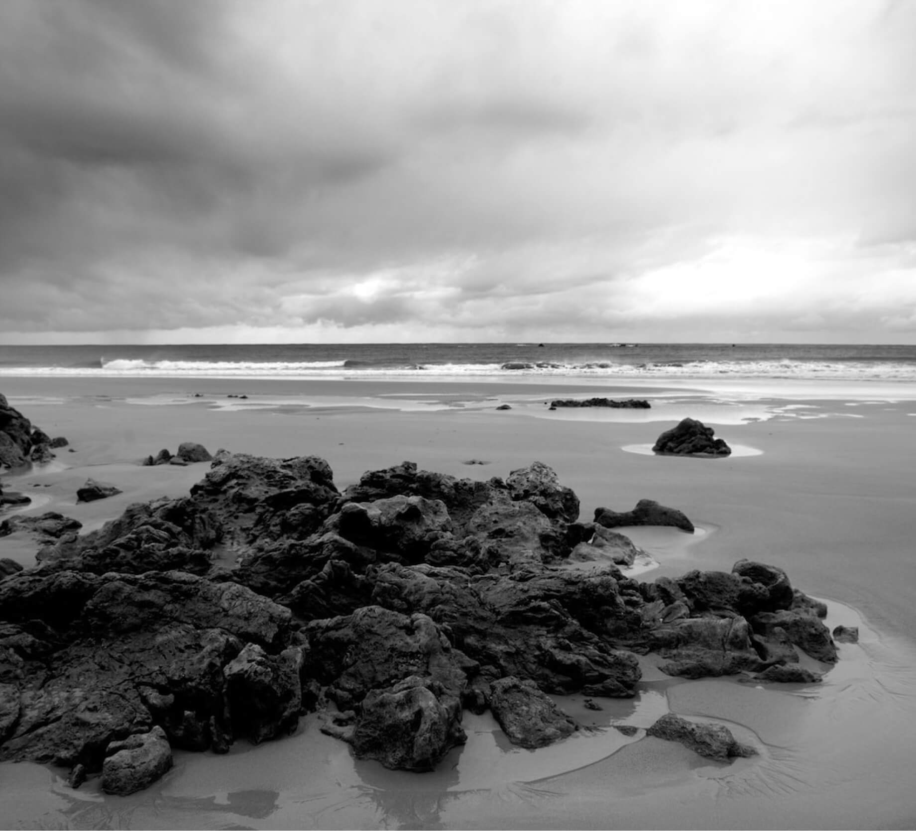 greyscale-beach-surrounded-by-ro_1_1.jpg